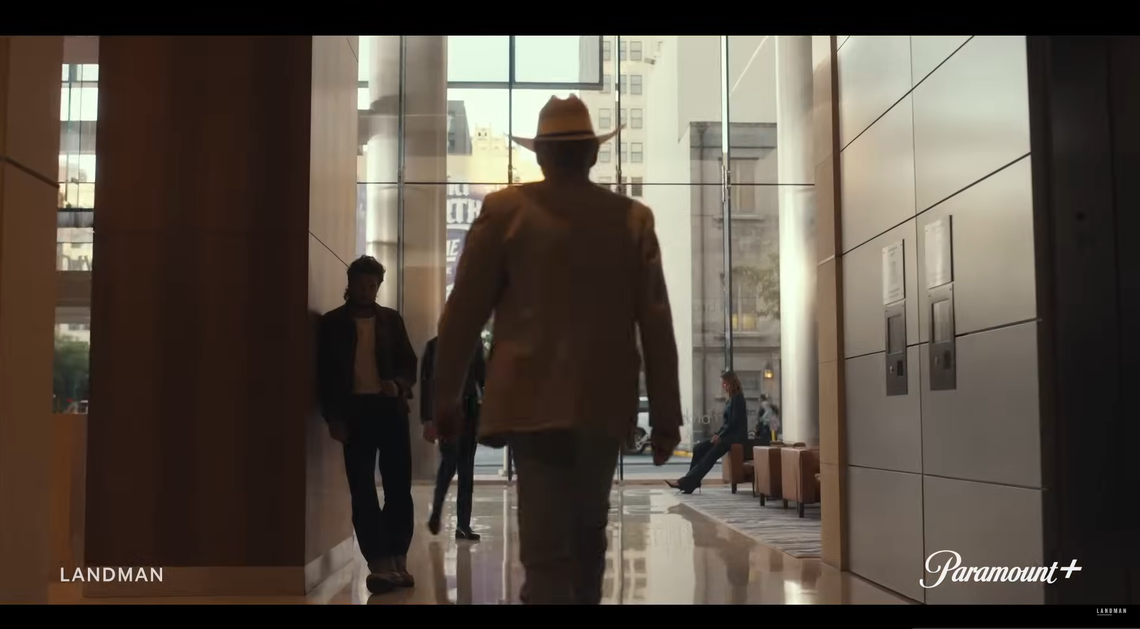 Tommy Norris walks through the Frost Tower lobby in the “Landman” Season 2 official trailer.