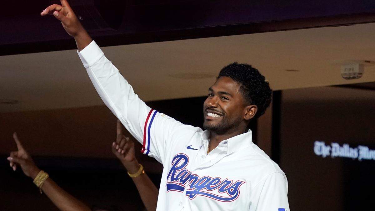 Texas Rangers’ Kumar Rocker acknowledges applause from fans after being introduced during Thursday’s game against the White Sox.