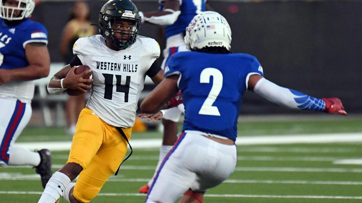 Western Hills quarterback Keyon Butler, left scrambles on a fourth down play into the open field to go 34 yards past Carter-Riverside’s Jackobi Tucker and a touchdown to take a 13-10 lead in the second quarter of Thursday’s September 22, 2022 District 6-4A Division 1 football game at Scarborough Handley Field in Fort Worth, Texas. Special/Bob Haynes