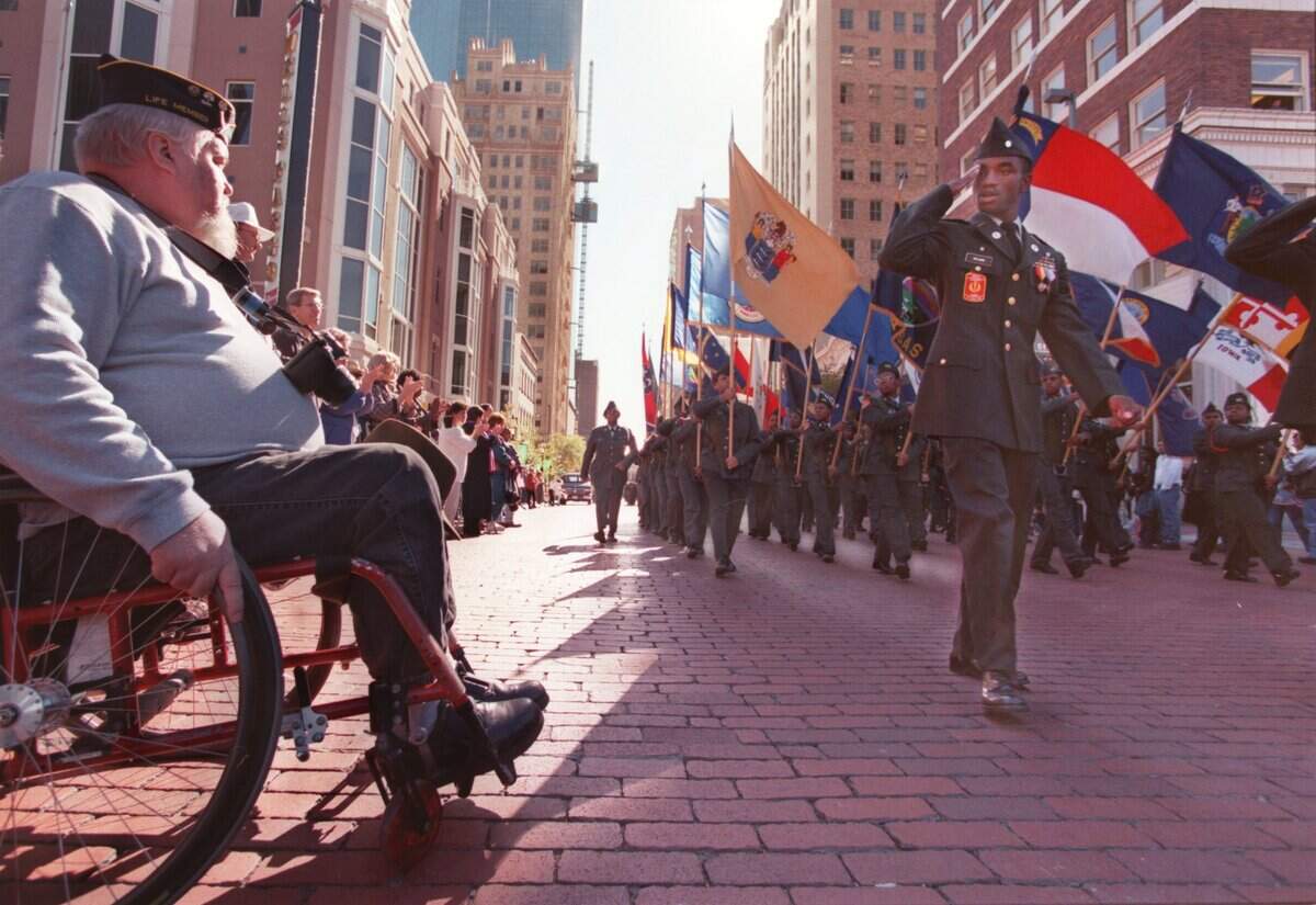 Nov. 11, 1998: Vietnam veteran C.J. Swanson, 53, of Fort Worth watches as the O.D. Wyatt High School honor band goes by during the Veterans Day parade in downtown.