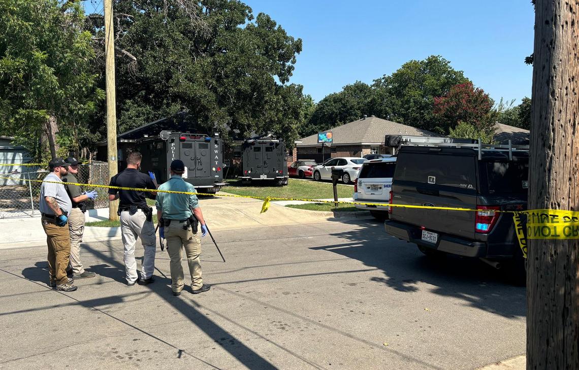Law enforcement on the 2900 block of Elinor Street near the home where a 40-year-old man barricaded himself after shooting a Tarrant County sheriff’s deputy three times on Wednesday, August 7, 2024.