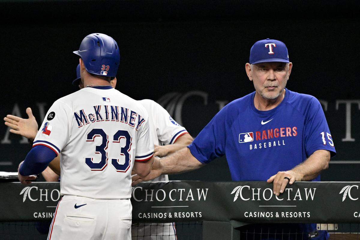 Sep 24, 2025; Arlington, Texas, USA; Texas Rangers manager Bruce Bochy (15) greets right fielder Billy McKinney (33) in the dugout during the seventh inning at Globe Life Field. Mandatory Credit: Jerome Miron-Imagn Images
