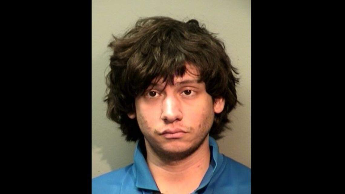 Andrew Peppers of Benbrook is accused of trying to rob a Fort Worth Domino's while wearing a Domino's shirt and hat.