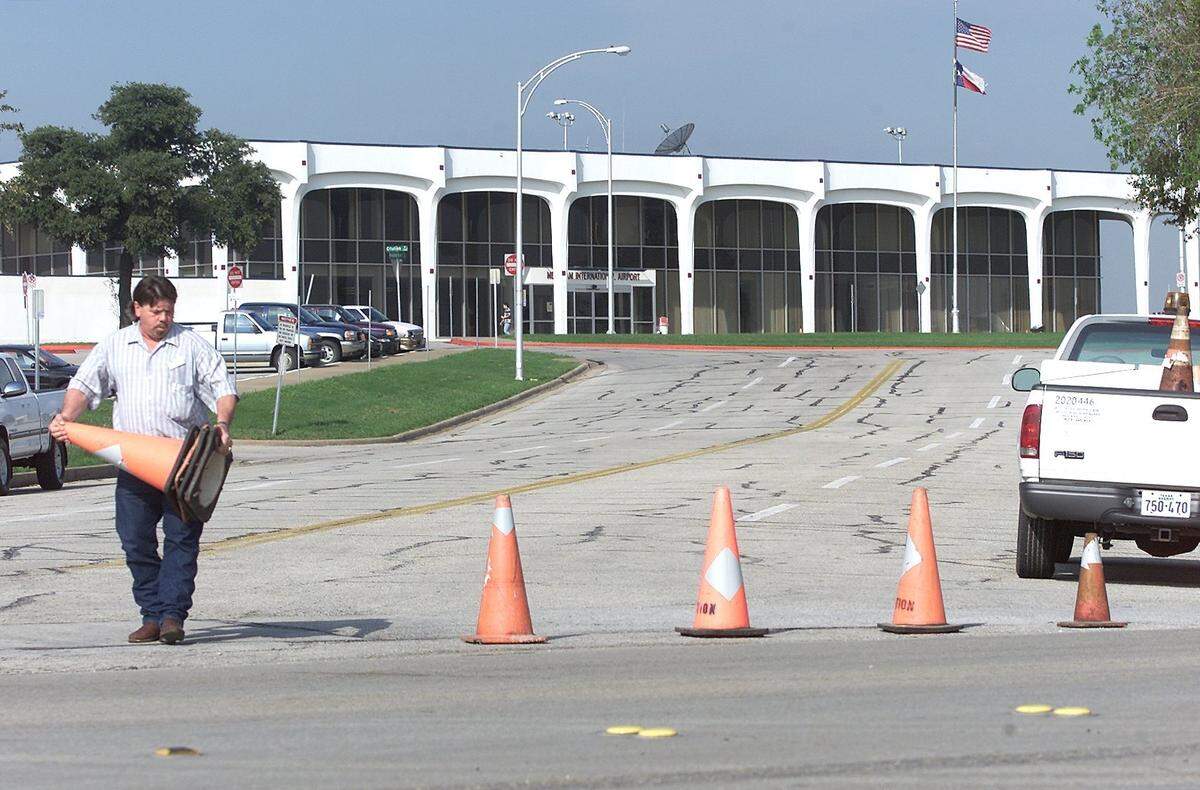 Mike Stewart of the Fort Worth aviation department lays traffic cones as his department and the Fort Worth Police Department begin to secure the perimeter of Meacham Airport on the morning of Sept. 11, 2001, after terrorists attacked the World Trade Center and the Pentagon.