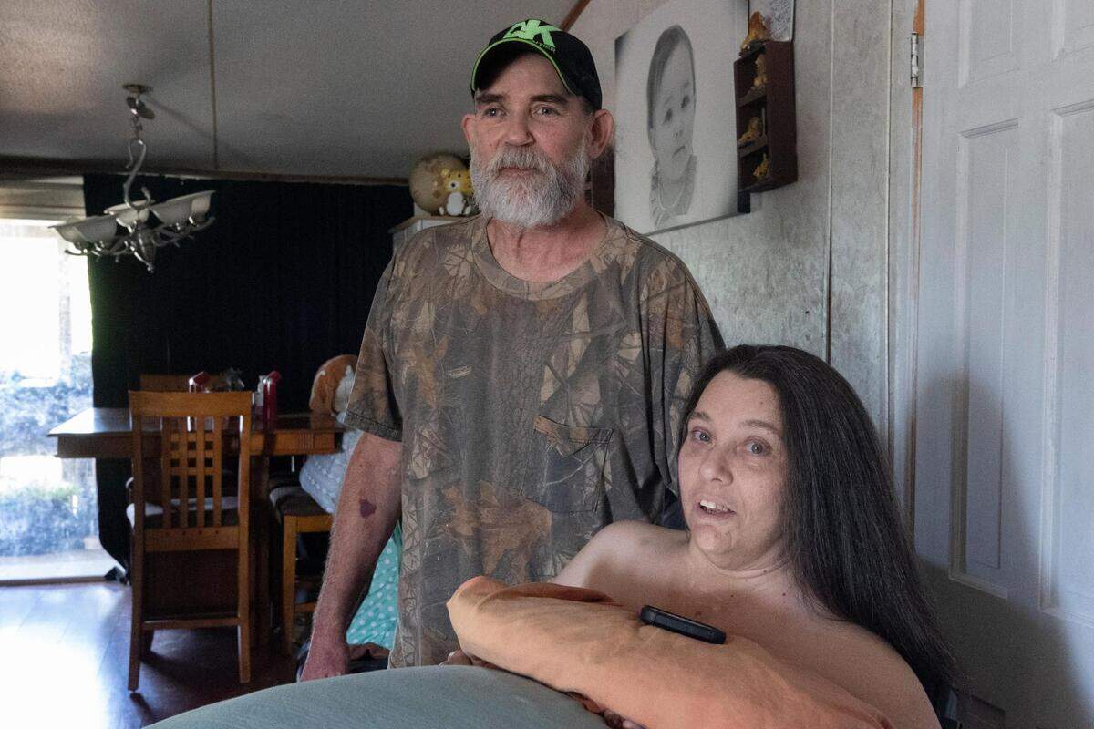 Christy and Kenneth Schwartz in their home on Wednesday, July 13, 2022, in Joshua, Texas. Christy was paralyzed in 2007 after being struck by a car, and Kenneth became her full-time caretaker.