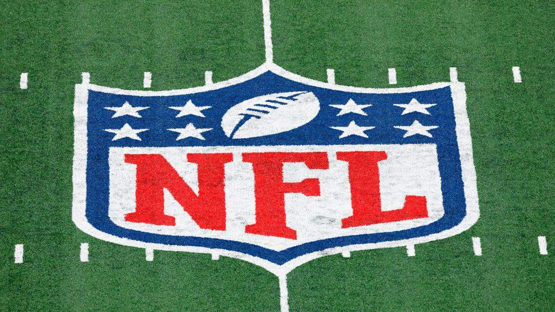 FILE - In this Nov. 2, 2020, file photo, the NFL logo is displayed at midfield during an NFL football game between the Tampa Bay Buccaneers and the New York Giants in East Rutherford, N.J. (AP Photo/Adam Hunger, FIle)