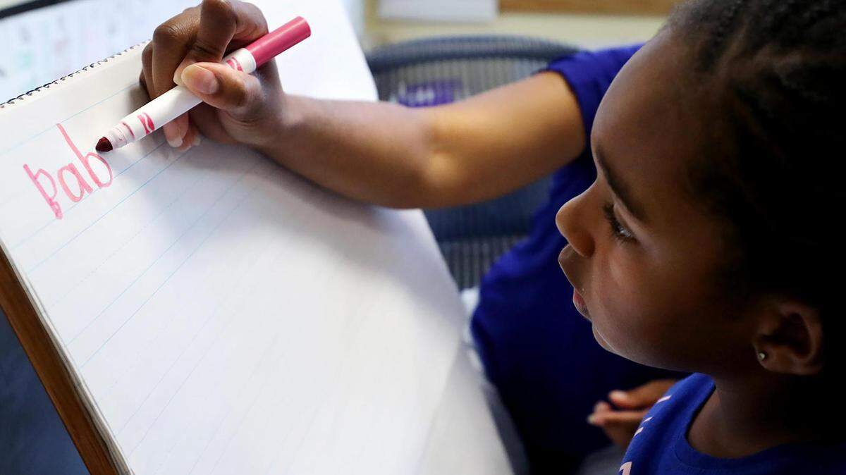 Chrisette Hanson, 4, works with Tequila Lockridge, a leveled literacy interventionist at UCC Polytechnic Center, during summer school last year.. Fort Worth ISD used federal COVID relief dollars to expand its summer school program.