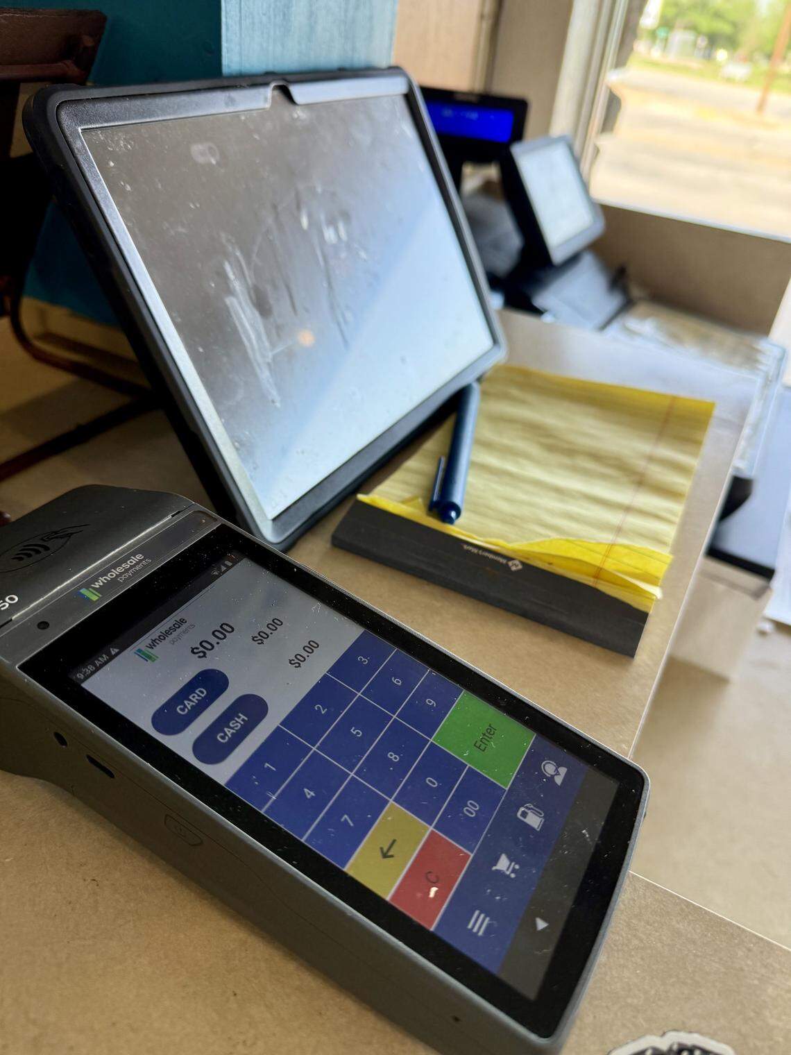 A new credit card machine seen April 16, 2026, at the checkout counter at Carshon’s Delicatessen, one of the last cash-only holdouts among Texas restaurants.
