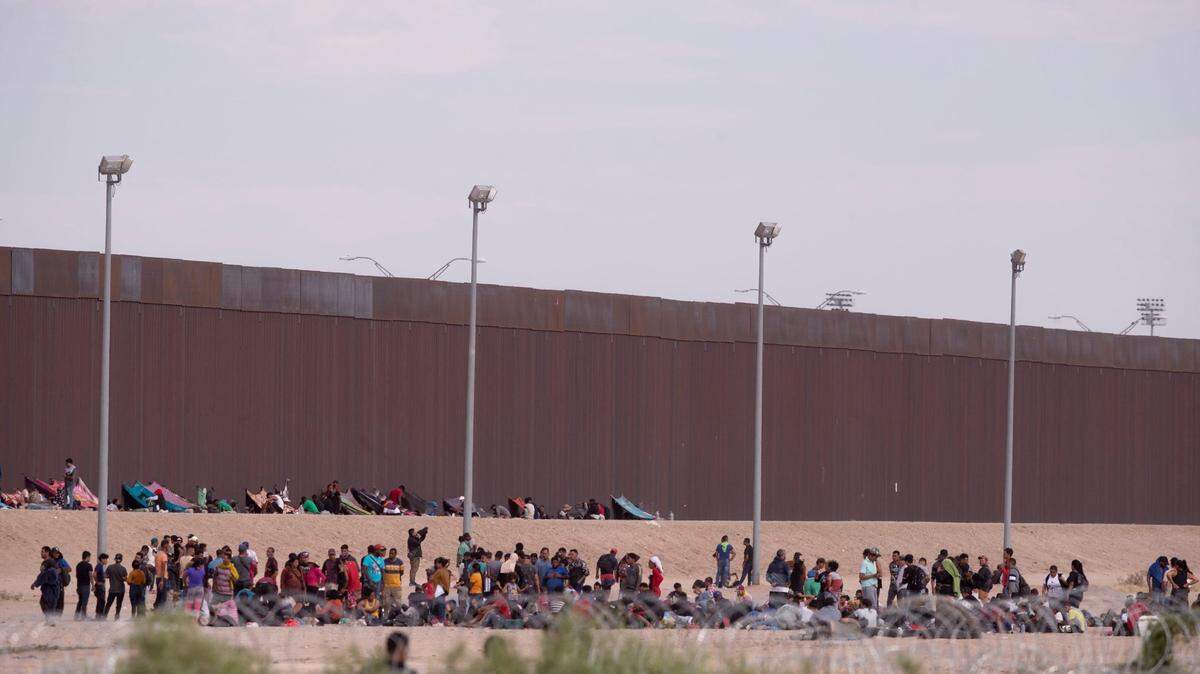 Migrants wait to be processed by Border Patrol in September at the border wall on the border between Ciudad Juarez and El Paso.