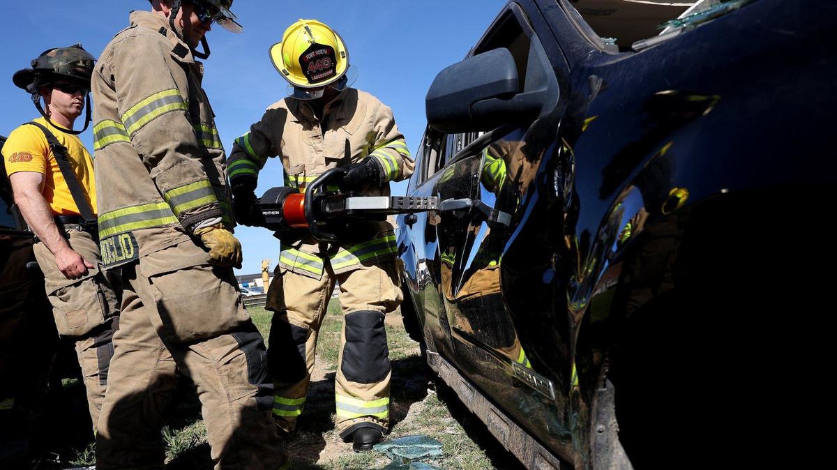 Fort Worth District 4 City Councilmember Charles Lauersdorf, right, learns how to use a tool for extracting victims from vehicles on Friday. City officials were invited to participate in a training session to learn what firefighters face on a day-to-day basis.