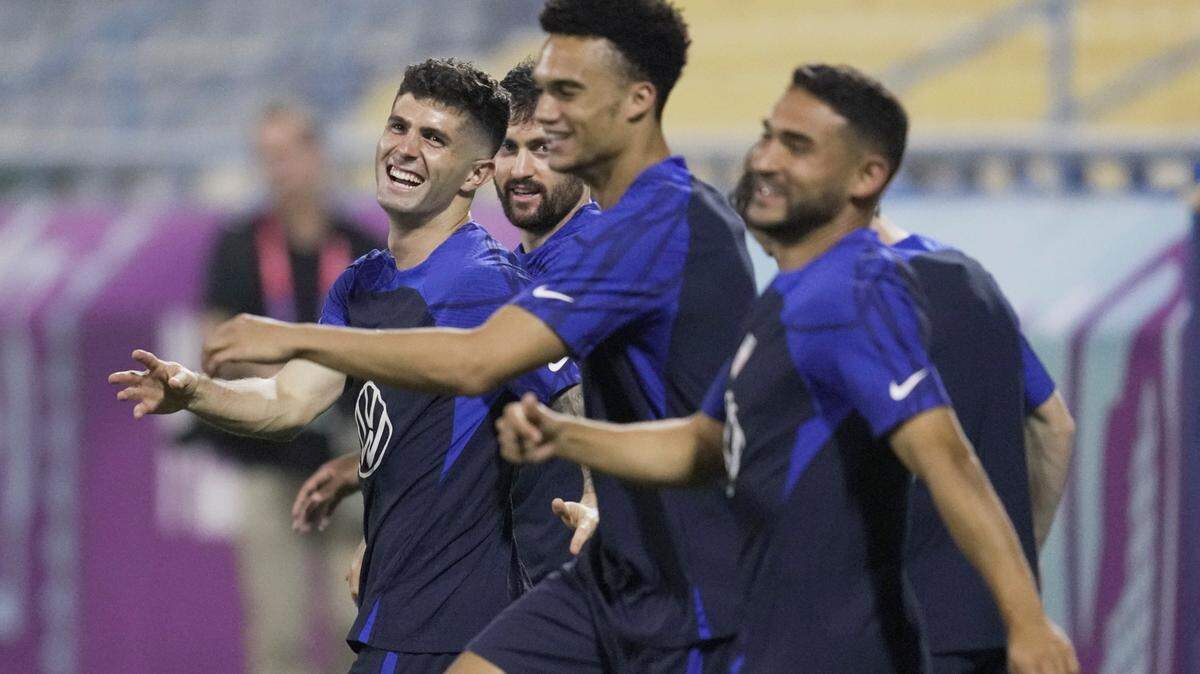 United States forward Christian Pulisic, left, and other players participate in an official training session at Al-Gharafa SC Stadium, in Doha, Saturday, Nov. 19, 2022. (AP Photo/Ashley Landis)