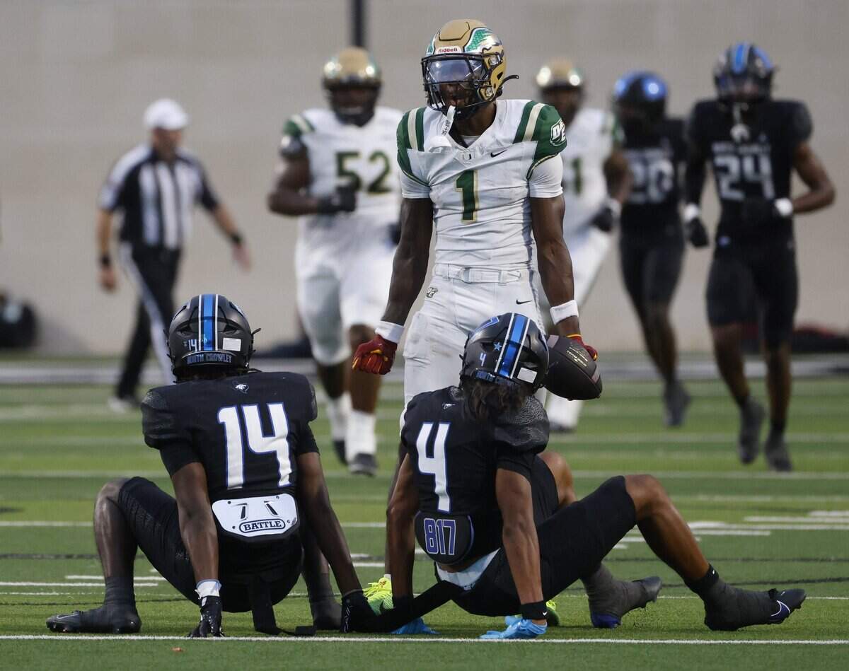 DeSoto wide receiver Ethan Feaster (1) taunts North Crowley safety Zion Miller (14) and corner back Jerry Outhouse (4) after his catch during the first half of a UIL football game between DeSoto and North Crowley at Crowley ISD Multi-Purpose Stadium in Fort Worth, Texas, Friday, Sept. 05, 2025.