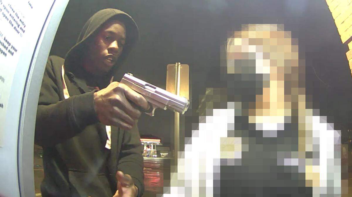 A man is captured in an ATM photo pointing a gun at a woman depositing money at the Bank of America near TCU, at 3100 S. University Drive. Police say he demanded money.