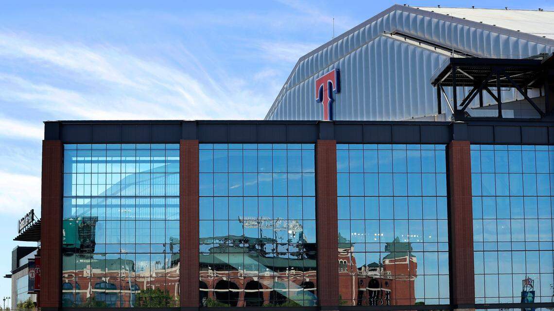 The Texas Rangers’ old stadium is reflected on the exterior wall of the club’s new home, Globe Life Field, which should have hosted 12 games so far this season. Until MLB announces its plans for the 2020 season, the Rangers can’t move forward with alternative plans for ticket holders.
