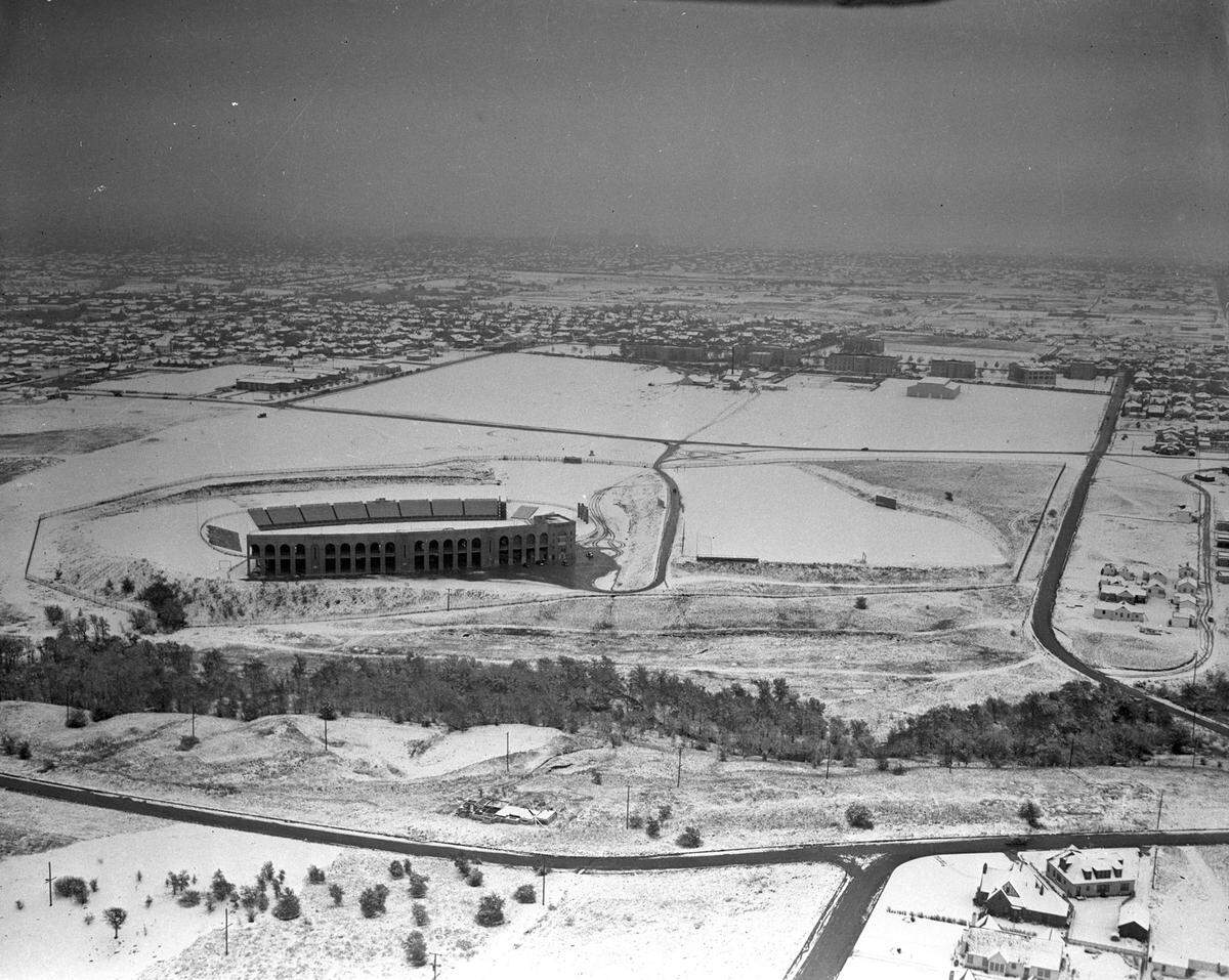 1938: “Air view of Texas Christian University (T. C. U.) stadium in the snow with other university buildings and neighborhoods in background.”