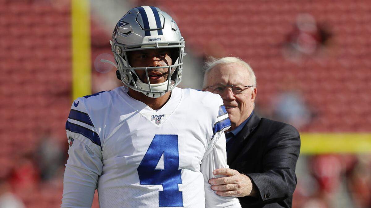 Dallas Cowboys owner Jerry Jones, right, stands behind quarterback Dak Prescott (4) as player warm up before an NFL preseason football game against the San Francisco 49ers in Santa Clara, Calif., Saturday, Aug. 10, 2019. (AP Photo/Josie Lepe)