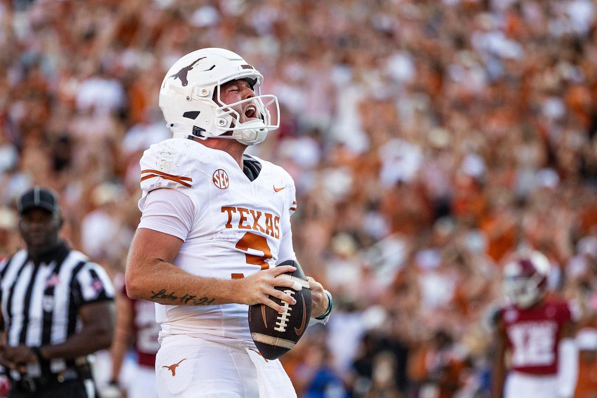 Texas quarterback Quinn Ewers (3) celebrates after rushing for a touchdown in the second half of the Red River Rivalry game at the Cotton Bowl in Dallas on Saturday, Oct. 12, 2024.