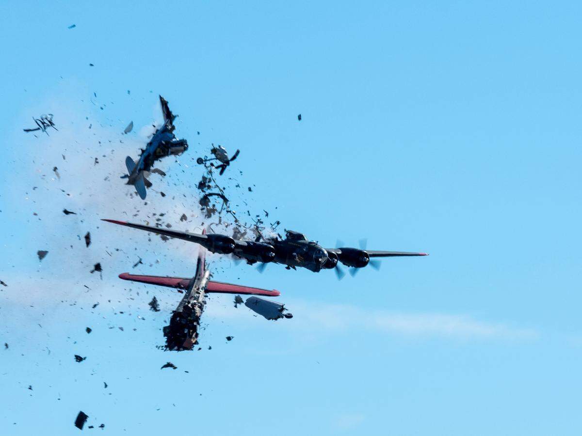 In this photo provided by Larry Petterborg, a Boeing B-17 Flying Fortress and a Bell P-63 Kingcobra collide in midair during an air show at Dallas Executive Airport in Dallas, Saturday, Nov. 12, 2022.