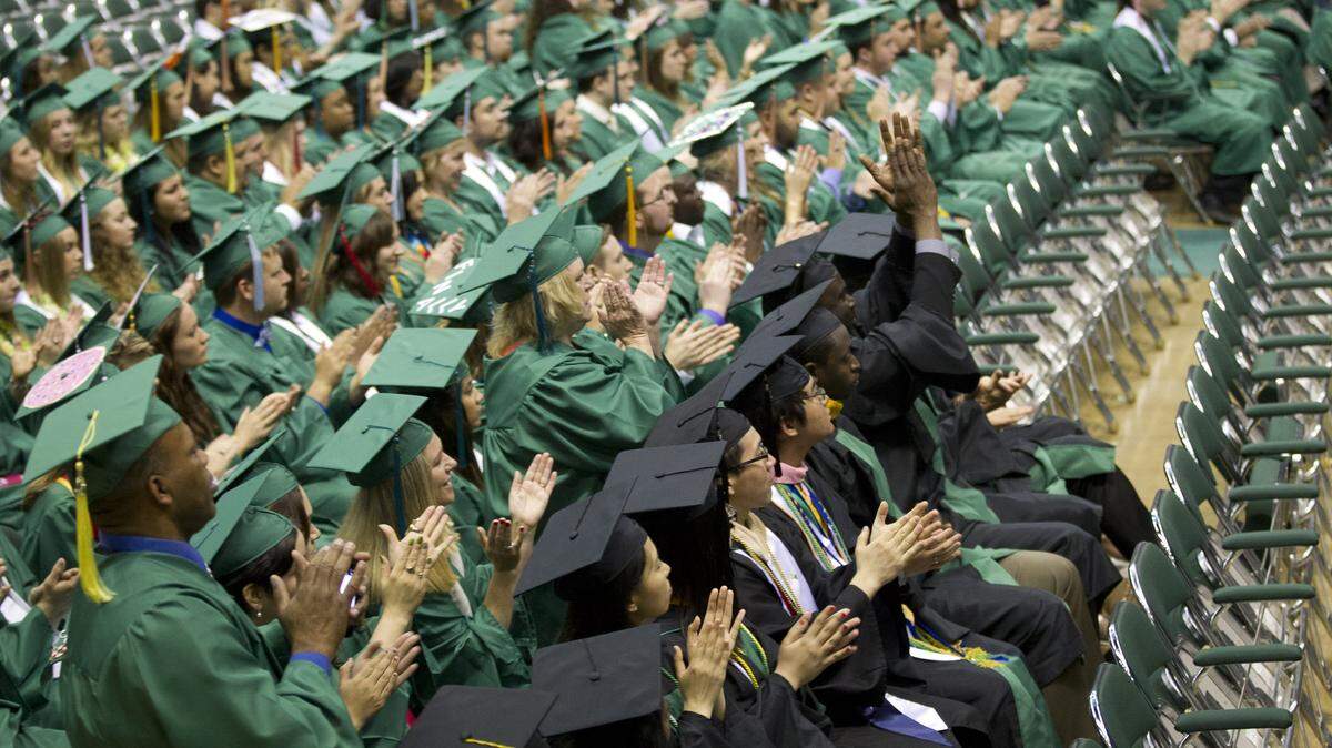 Students greet Texas Governor Greg Abbott who spoke at the UNT graduation on May 16, 2015, even though some students weren't happy about it.  (Star-Telegram/Joyce Marshall)