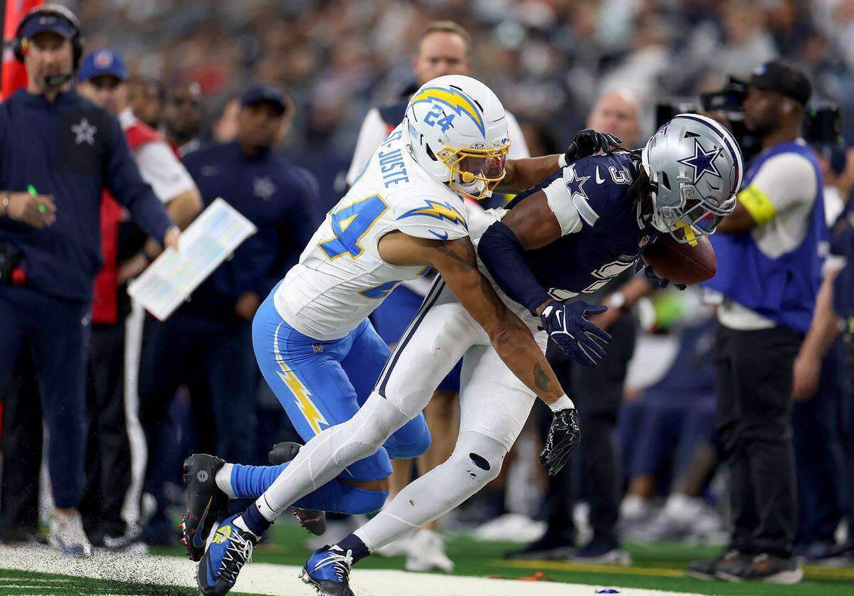 Dallas Cowboys wide receiver George Pickens is pushed out of bounds by Los Angeles Chargers cornerback Benjamin St-Juste after making the catch on Sunday, Dec. 21, 2025, at AT&T Stadium.
