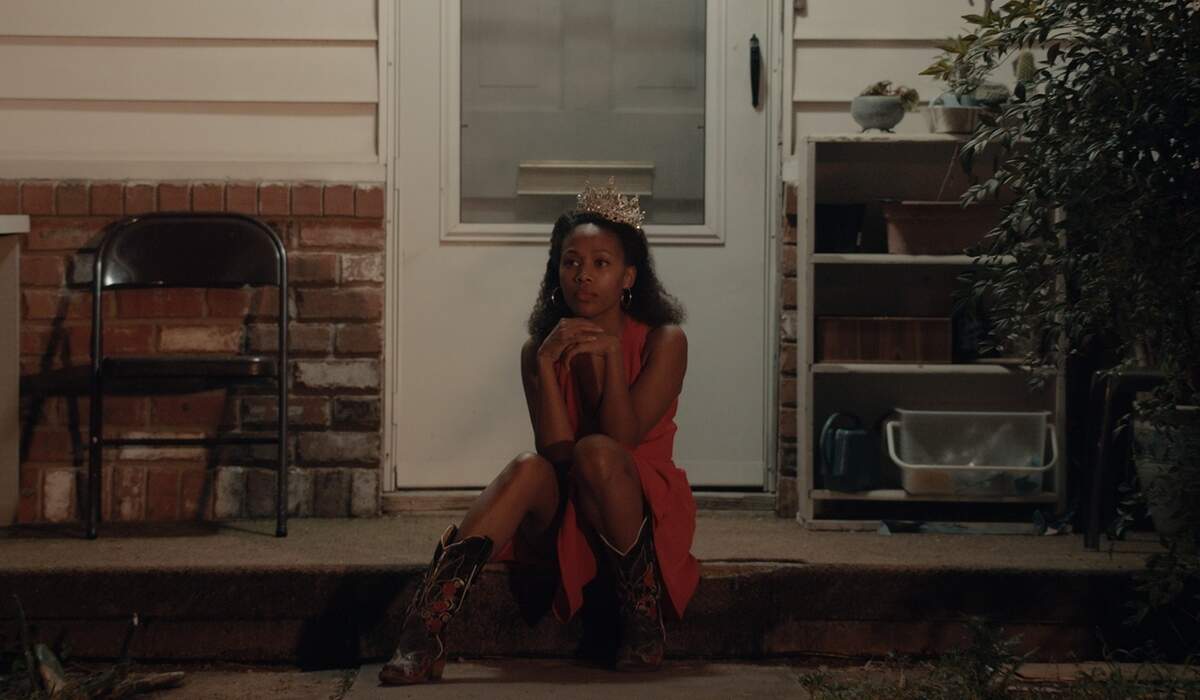 Nicole Beharie, playing the character Turquoise Jones in the film “Miss Juneteenth,” sits outside with a crown atop her head. The film is about the former beauty queen pushing her daughter to compete in the pageant so she can win a full scholarship to a historically black college and have a successful life.