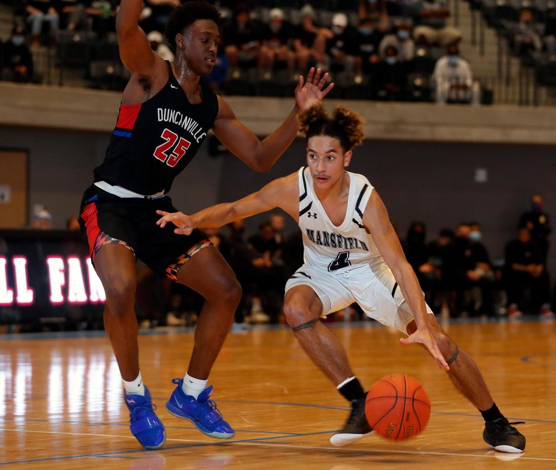 Mansfield guard Marquis Thibert (4) drives in on Duncanville guard Damon Nicholas (25) during the second half of a 6A Region 1 quarterfinal basketball game at Arlington ISD Athletics Complex in Arlington, Texas, Saturday, Feb. 27, 2021. Duncanville defeated Mansfield 73-53. (Special to the Star-Telegram Bob Booth)
