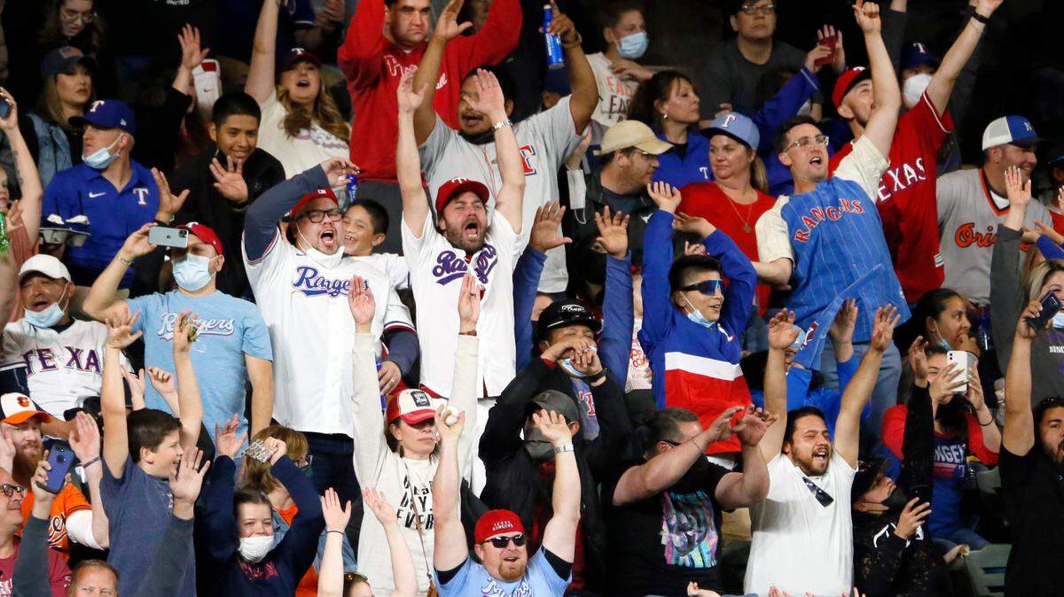 Fans at Globe Life Field do “The Wave” between innings of a baseball game between the Texas Rangers and the Baltimore Orioles in Arlington, Texas, Saturday, April 17, 2021. (AP Photo/Ray Carlin)