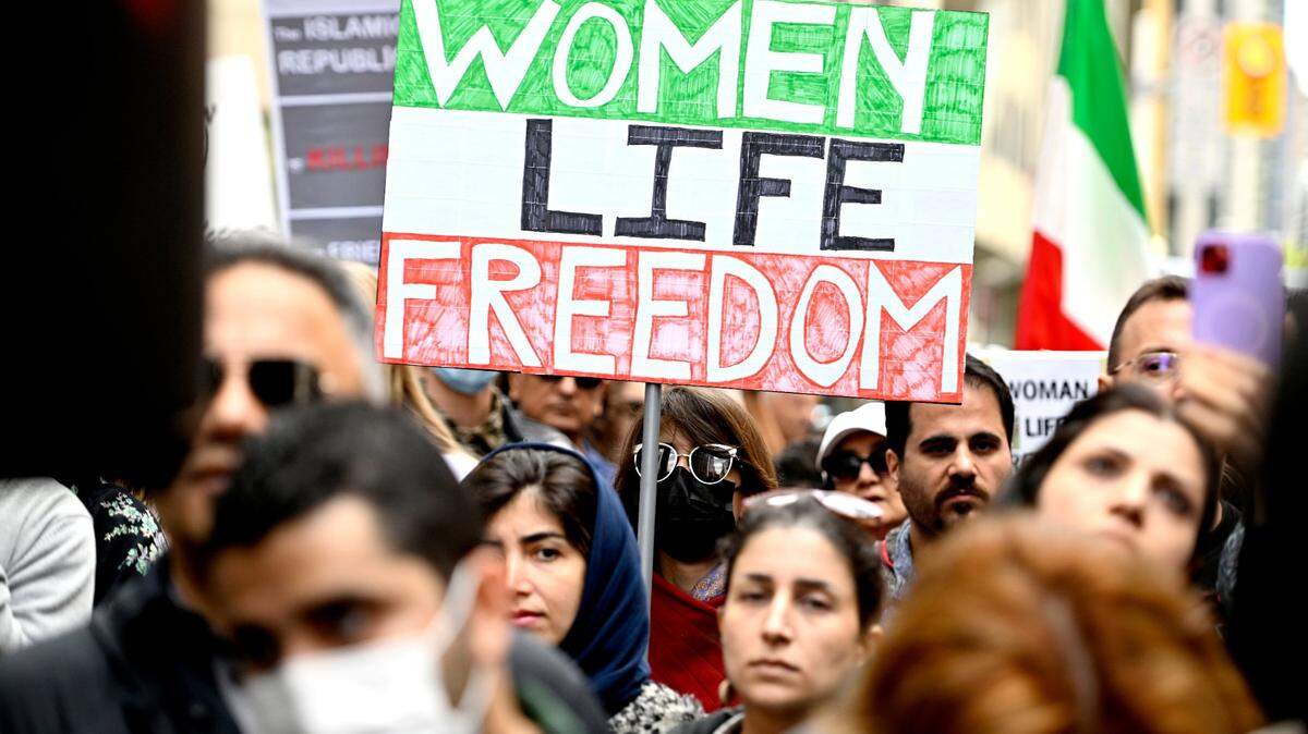 Members of the Iranian community and their supporters rally Sunday in Ottawa, the Canadian capital, in solidarity with protesters in Iran, after 22-year-old Mahsa Amini died in police custody for allegedly improperly wearing a hijab. (Justin Tang/The Canadian Press via AP)