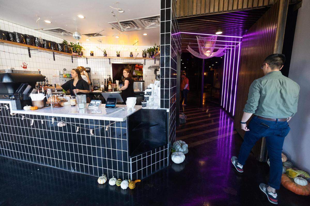 Toan Luong walks through the coffee shop, which doubles as a nightlife spot serving bar drinks.