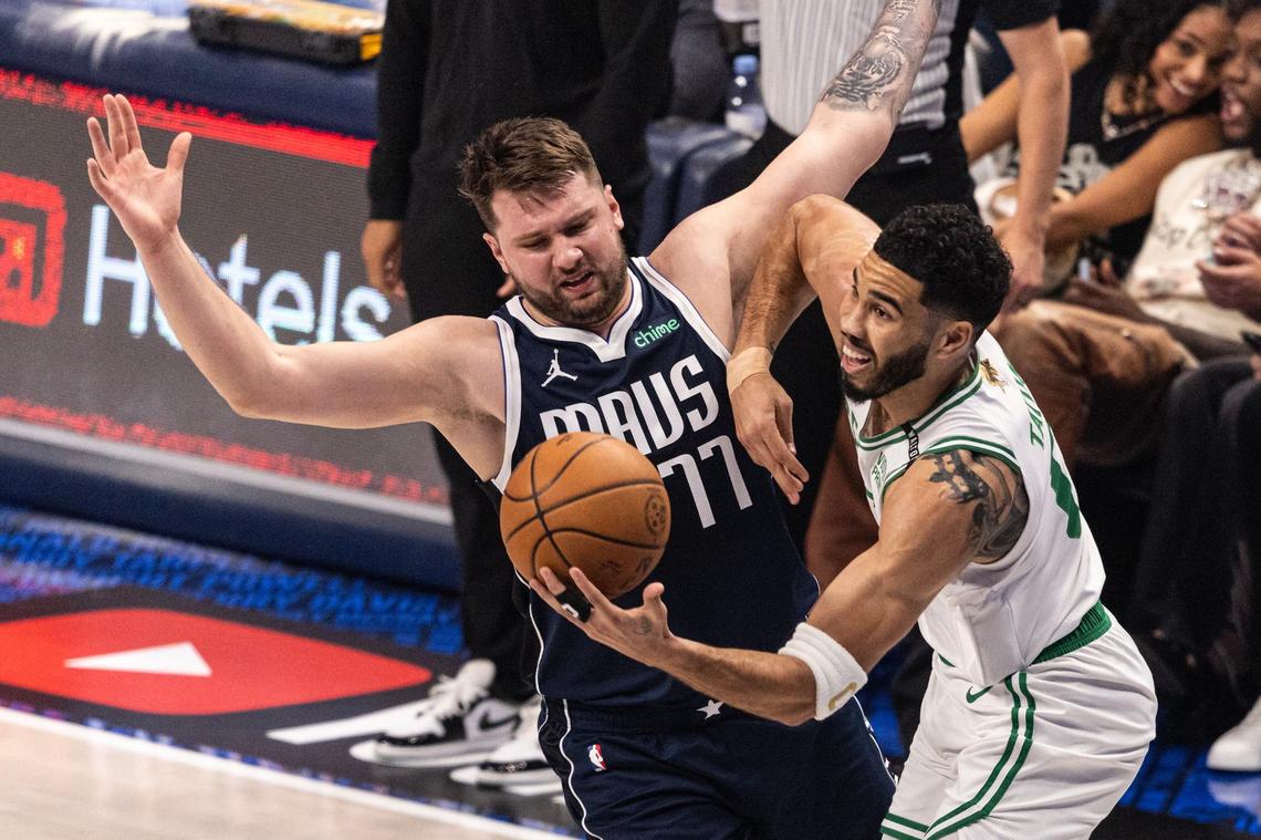 Dallas Mavericks guard Luka Doncic (77) guards Boston Celtics guard Jayson Tatum (0) in the first quarter of game 3 of the 2024 NBA Finals at American Airlines Center in Dallas on Wednesday, June 12, 2024.