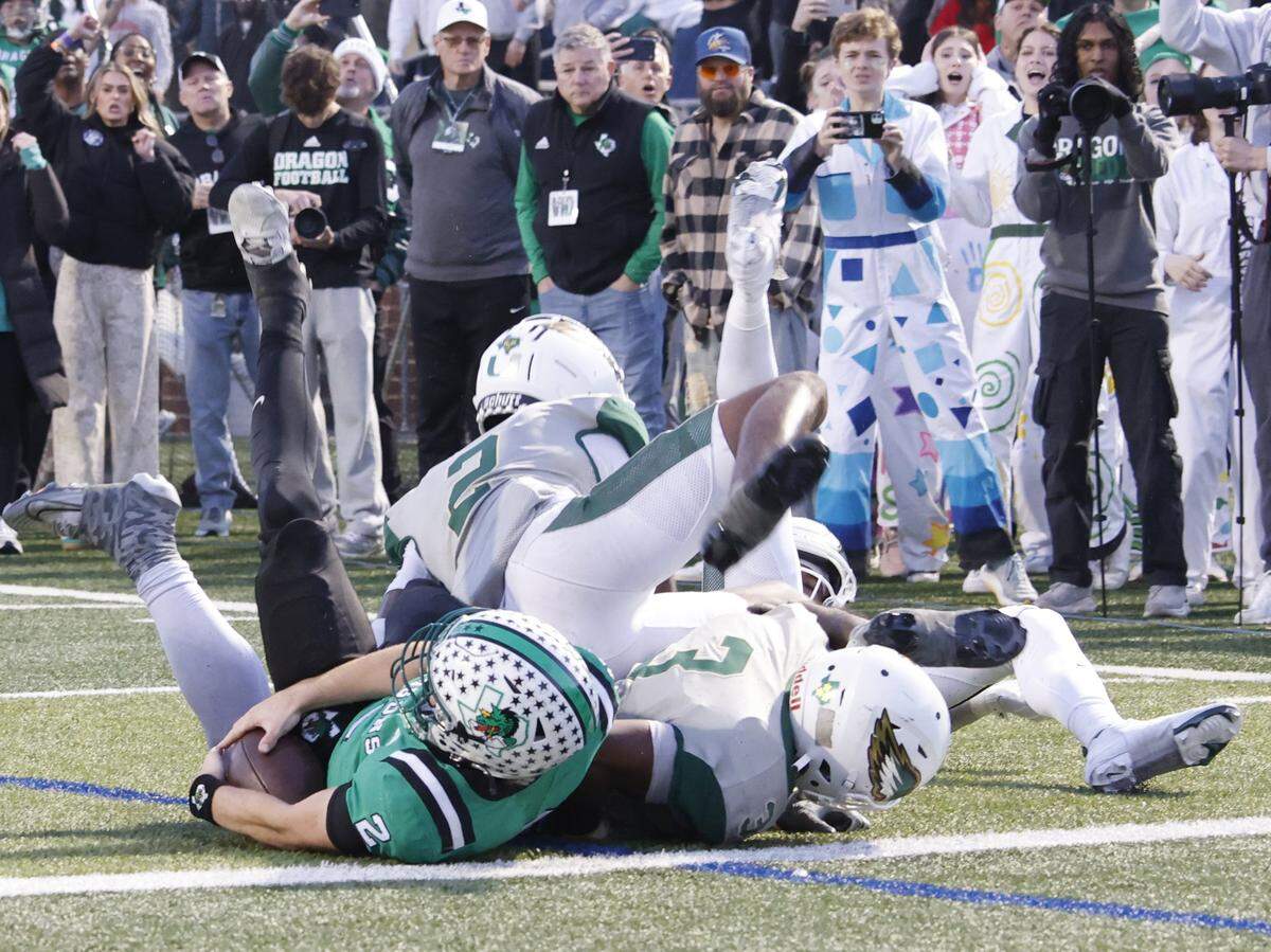 Southlake Carroll quarterback Angelo Renda (left) is kept out of the end zone by DeSoto in the final seconds of a Class 6A Division II state semifinal Saturday at Newsom Stadium in Mansfield.