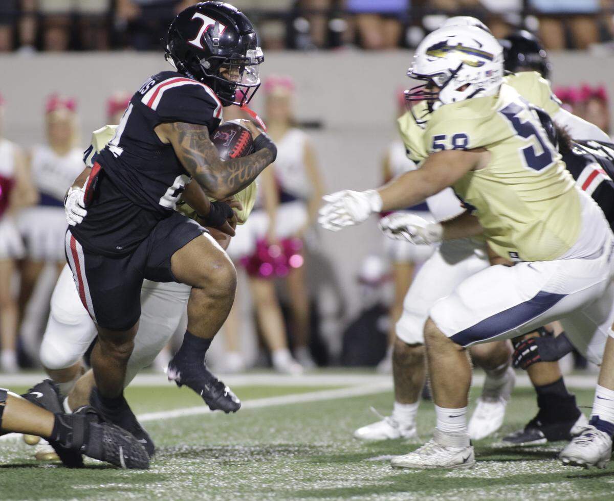 Euless Trinity running back JT Harris carries the ball against Keller during their game on Friday, October 17, 2025 at Pennington Field in Bedford, Texas.