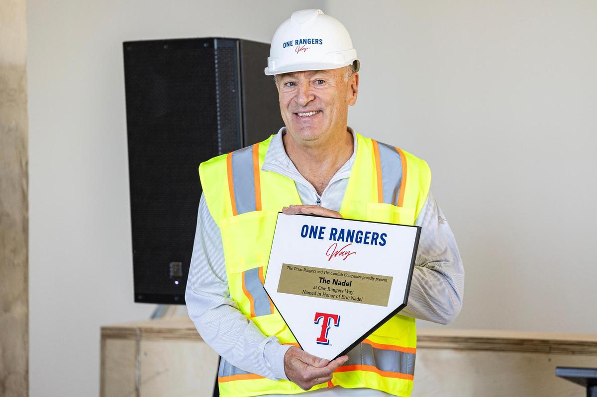 Texas Rangers Hall of Fame broadcaster Eric Nadel is presented with a plaque for having his own floor plan named after him in the One Rangers Way residential apartment complex in the Arlington Entertainment District on Tuesday, Nov. 12, 2024.