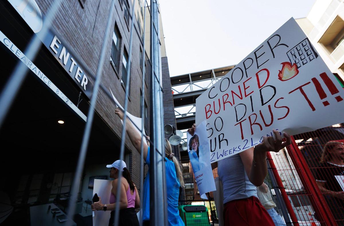 Residents of The Cooper protest a lack of communication from the management and owners of the apartment complex on Monday, July 7, 2025. Residents, who have not been able to occupy their residences for two weeks following a six-alarm fire, were demanding to speak with management.