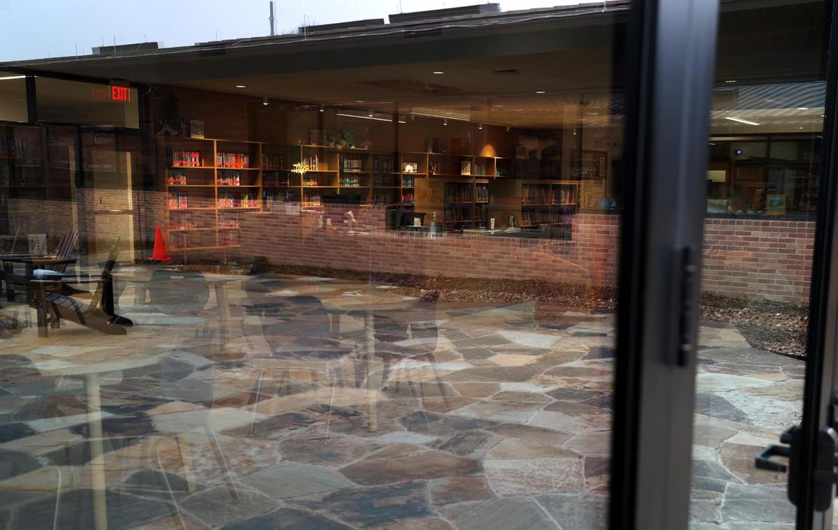 The library of the new Annie Richardson Bass Lower School can be seen through glass doors that can be opened onto a courtyard on Tuesday, Feb. 18, 2025.