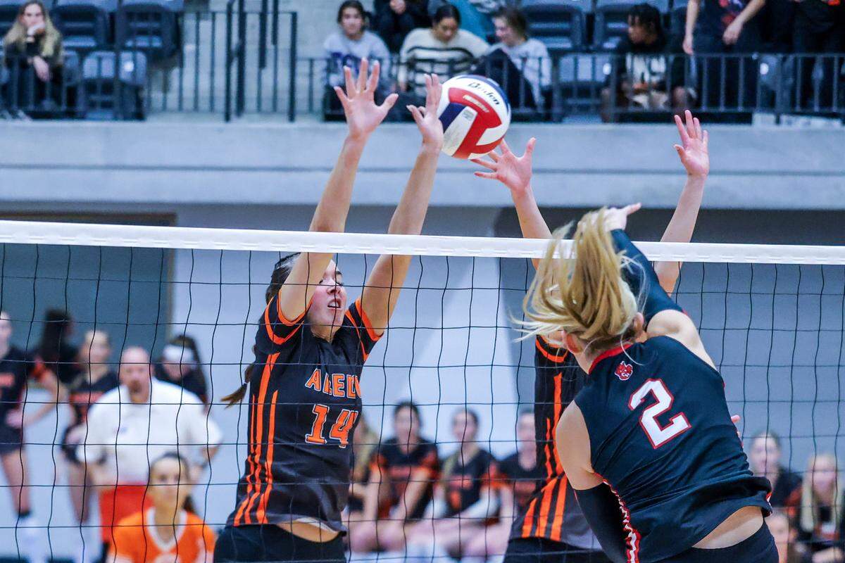 Audrey Popp (2) of Colleyville Heritage spikes the ball past Aledo’s Payton Patrick in Thursday’s bidistrict playoff game between Aledo and Colleyville Heritage at Arlington ISD Athletics Center, Thursday, Oct. 30, 2025.