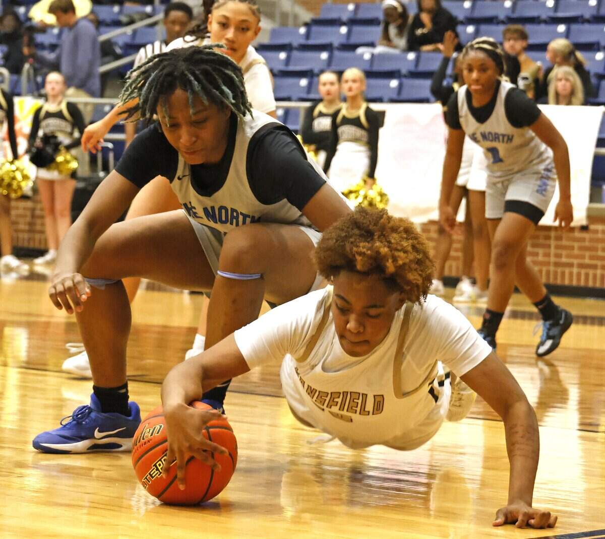 North Crowley forward Mecca Crawford (23) and Mansfield shooting forward J'nye Weaver (15) fight for a loose ball during the first half of a UIL girls basketball game between North Crowley and Mansfield at Mansfield High School in Mansfield, Texas, Tuesday Jan. 20, 2026