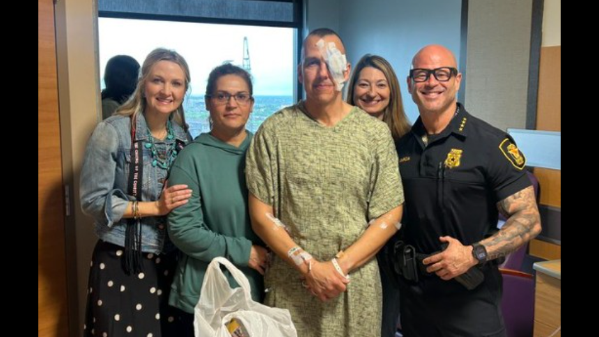 Fort Worth Mayor Mattie Parker, left, and Police Chief Eddie Garcia, right, visit Spc. Edward Zapata&nbsp;of the department’s Civilian Response Unit at John Peter Smith Hospital.