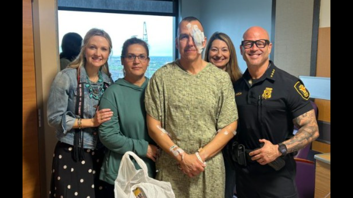 Fort Worth mayor Mattie Parker, left, and police chief Eddie Garcia visit Edward Zapata of the department’s Civilian Response Unit at John Peter Smith hospital.