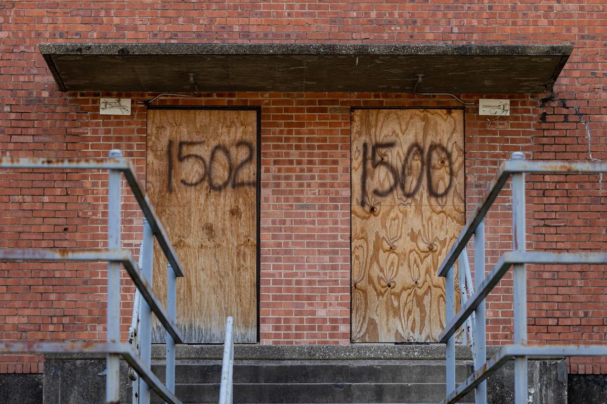 The windows and doors of apartments at Butler Place are boarded up. Most of the complex will likely be demolished as part of redevelopment.
