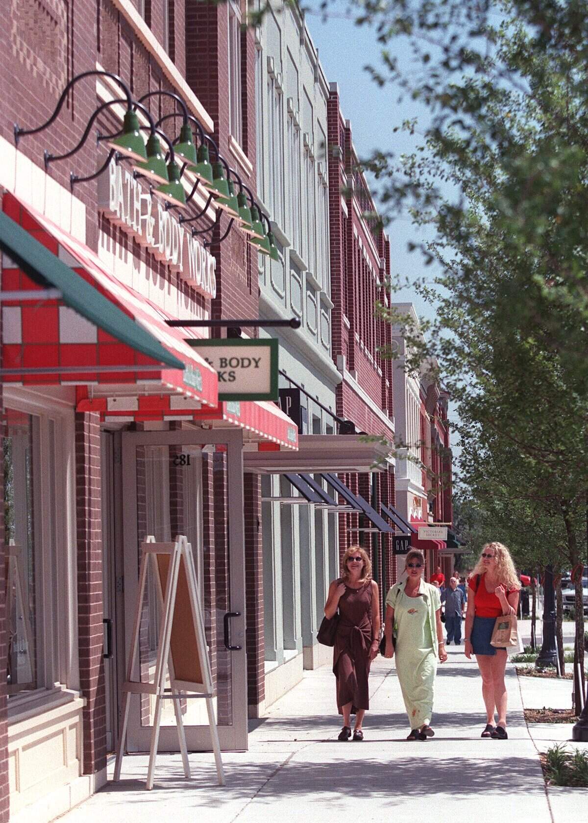 July 16, 1999: Susan Brice, left, Karen Dickey and Kim Maney walk along the sidewalk in front of Southlake Town Square.