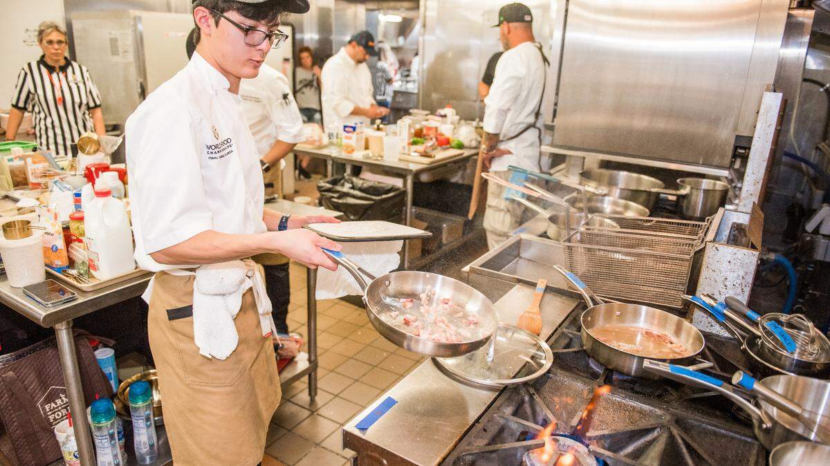 Preston Nguyen cooks on the stove at the World Food Championships “Final Table” in Columbia, South Carolina.