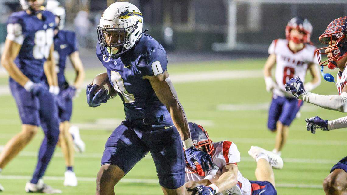 Keller running back Temi Ericson (0) breaks a tackle on his 25-yard touchdown in overtime to win a District 4-6A game against Justin Northwest on Friday at Keller ISD Stadium.