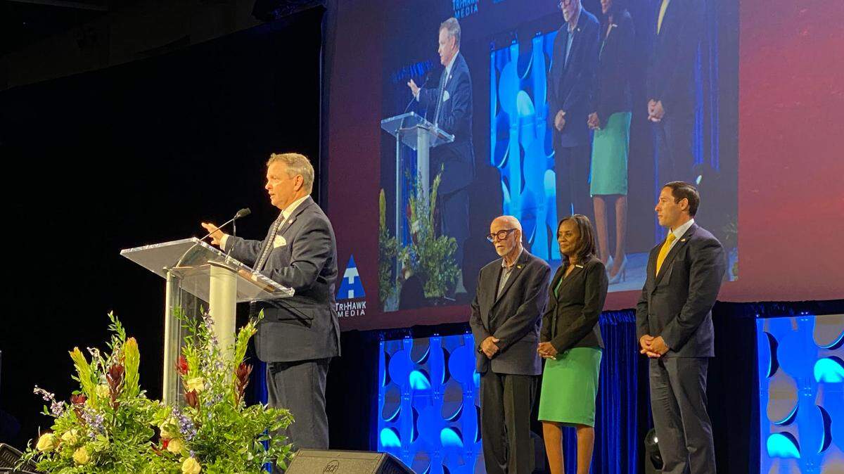 County Judge Tim O’Hare (left) stands on stage at his the State of the County address with commissioners Gary Fickes, Alisa Simmons and Manny Ramirez.