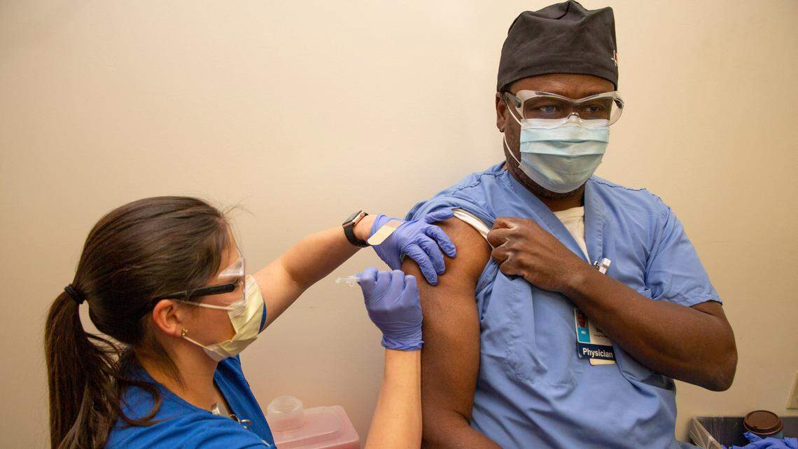 Dr. Herschel Brown, Emergency Department physician, receives a COVID-19 vaccine on Thursday at Texas Health Fort Worth. Tarrant County hospitals recently received allocations of the vaccine.