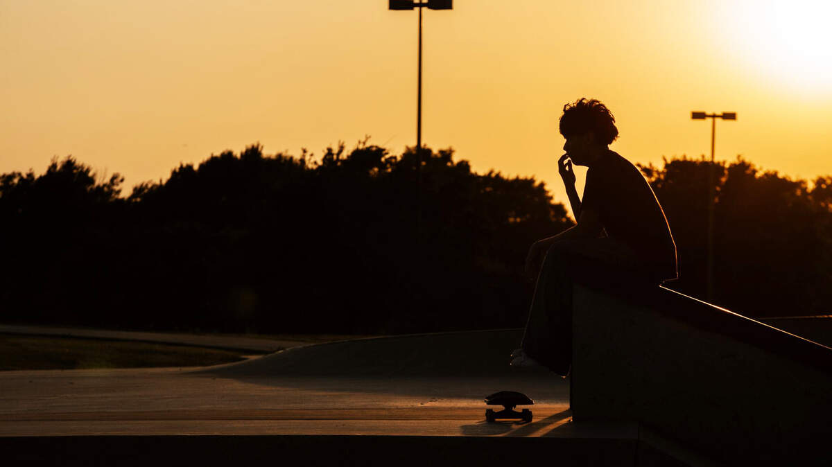 A skater sits on a ledge Silhouetted by the sun Thursday, June 27, 2024 at Vandergriff Park in Arlington.
