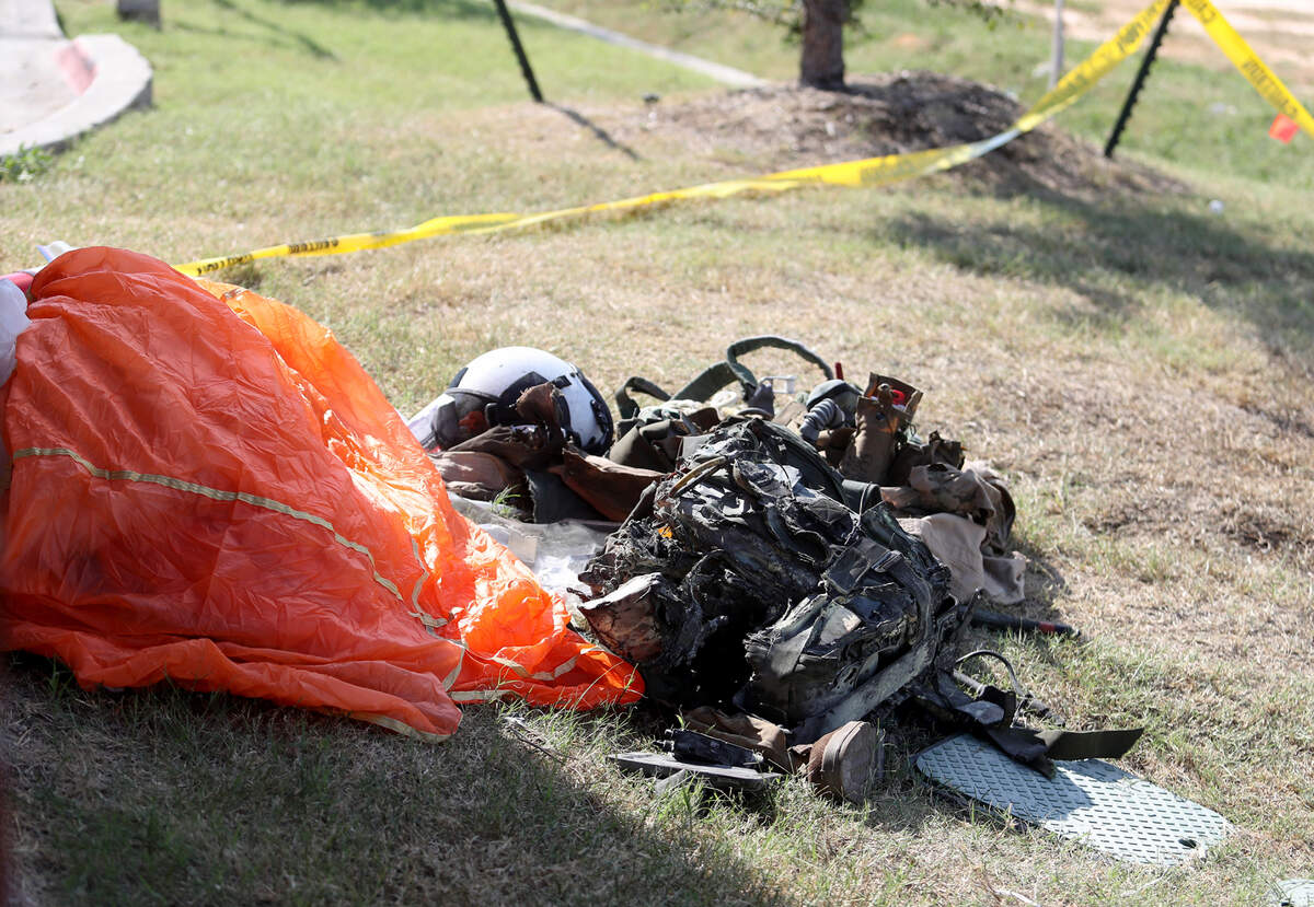 A parachute and gear from a Navy pilot who ejected before his military training jet crashed sits outside of Ole Donut on Sunday, September 19, 2021. Two Navy pilots who were on a training flight ejected from the plane and were taken to local hospitals with serious injuries, authorities said.