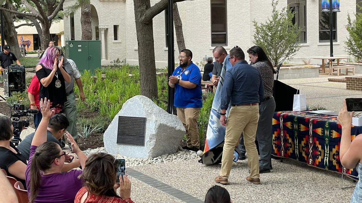 A 2-ton bolder with a plaque on it on the campus of the University of Texas at Arlington.