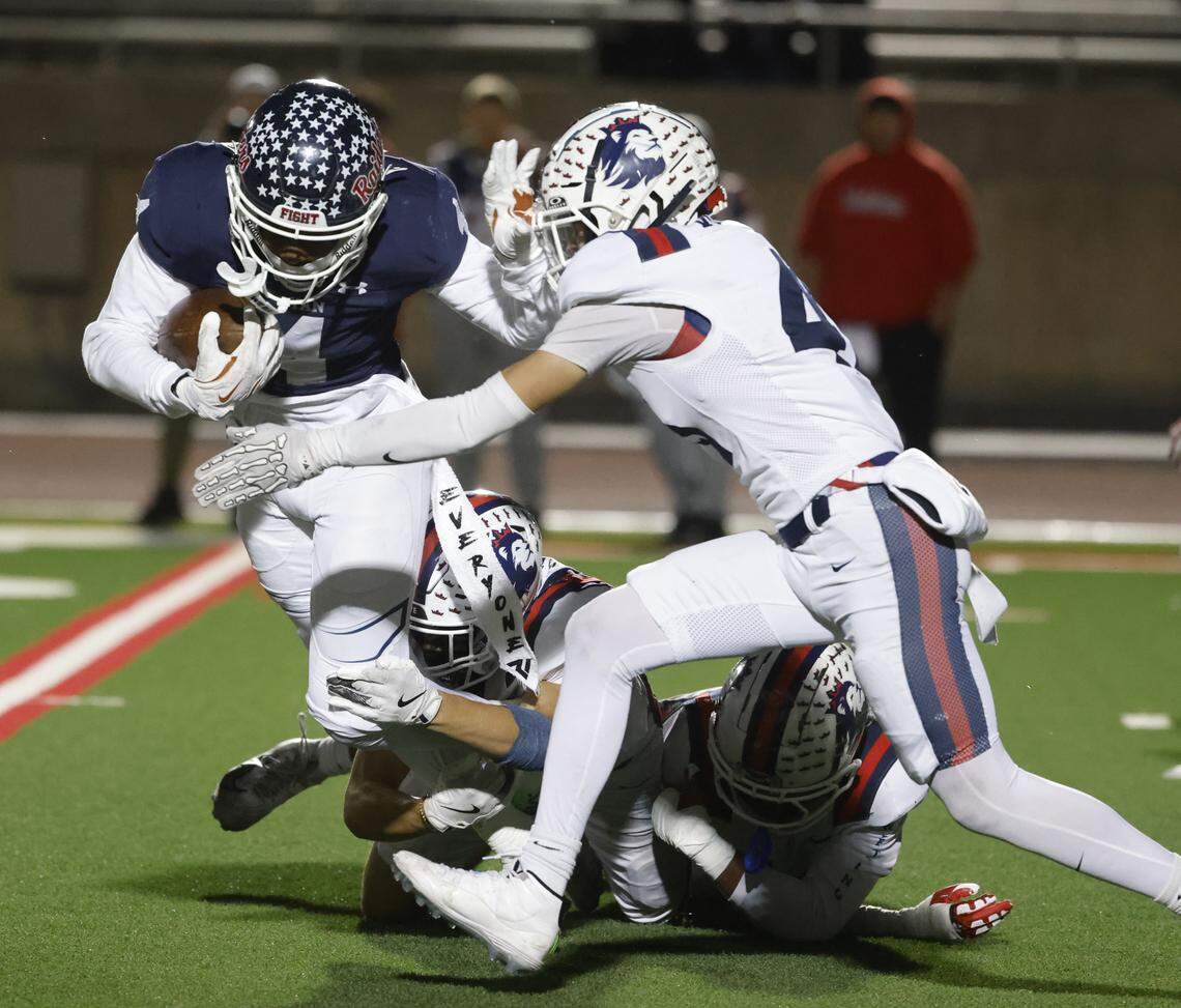 Denton Ryan running back Tre-Vaughn Reynolds (4) is brought down by the Richland defense during the first half of a UIL Class 5A Division I Regional on Friday Nov. 28, 2025 at Buddy Echols Field in Coppell, Texas.