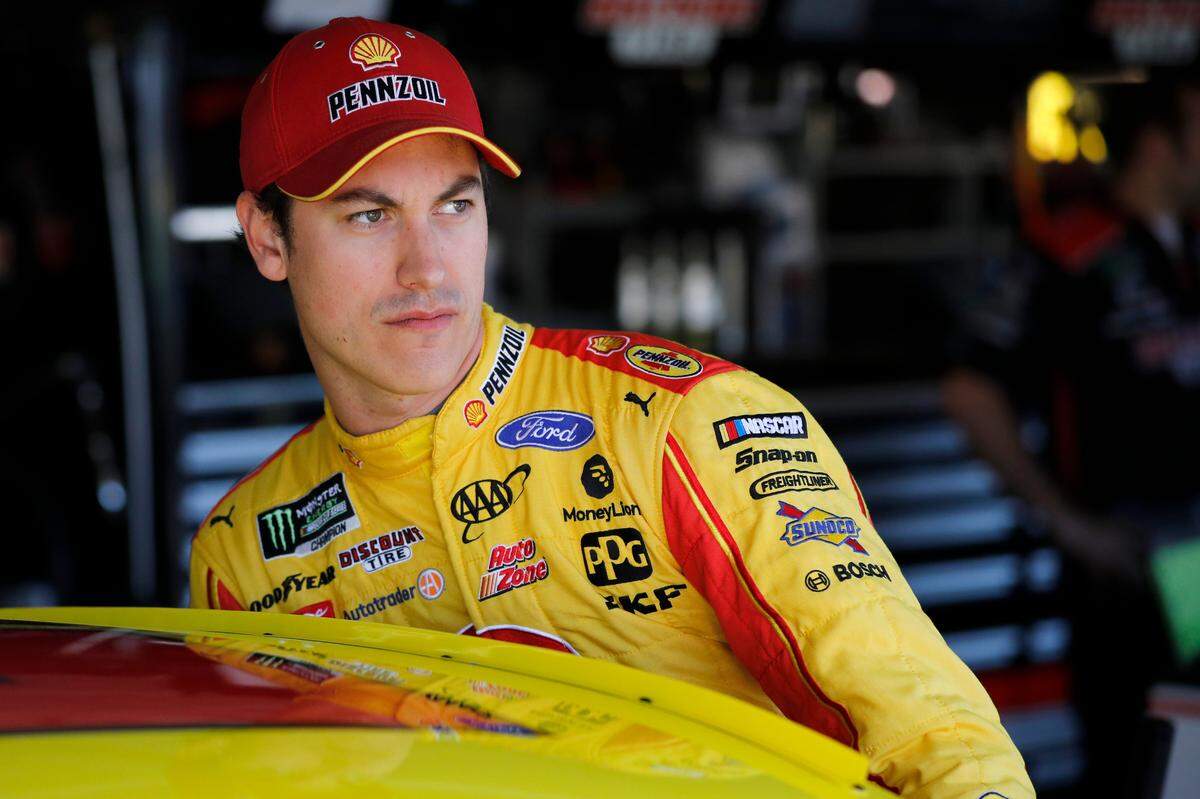 Joey Logano climbs into his car during practice for a NASCAR Cup Series auto race at Kansas Speedway in Kansas City, Kansas, Friday, Oct. 18, 2019.